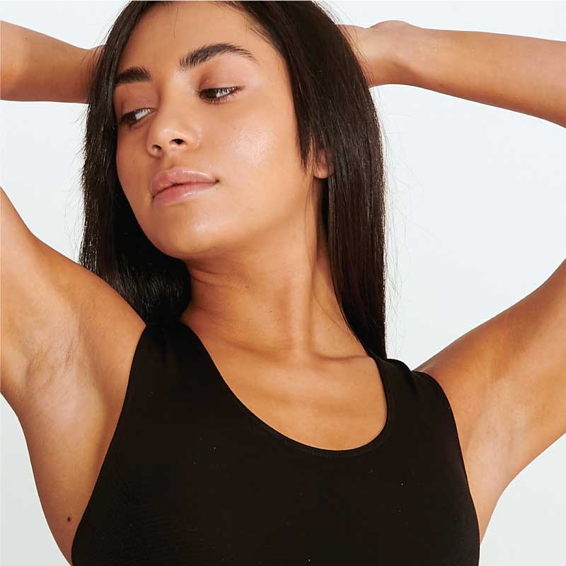 Woman with arms raised showing smooth underarms